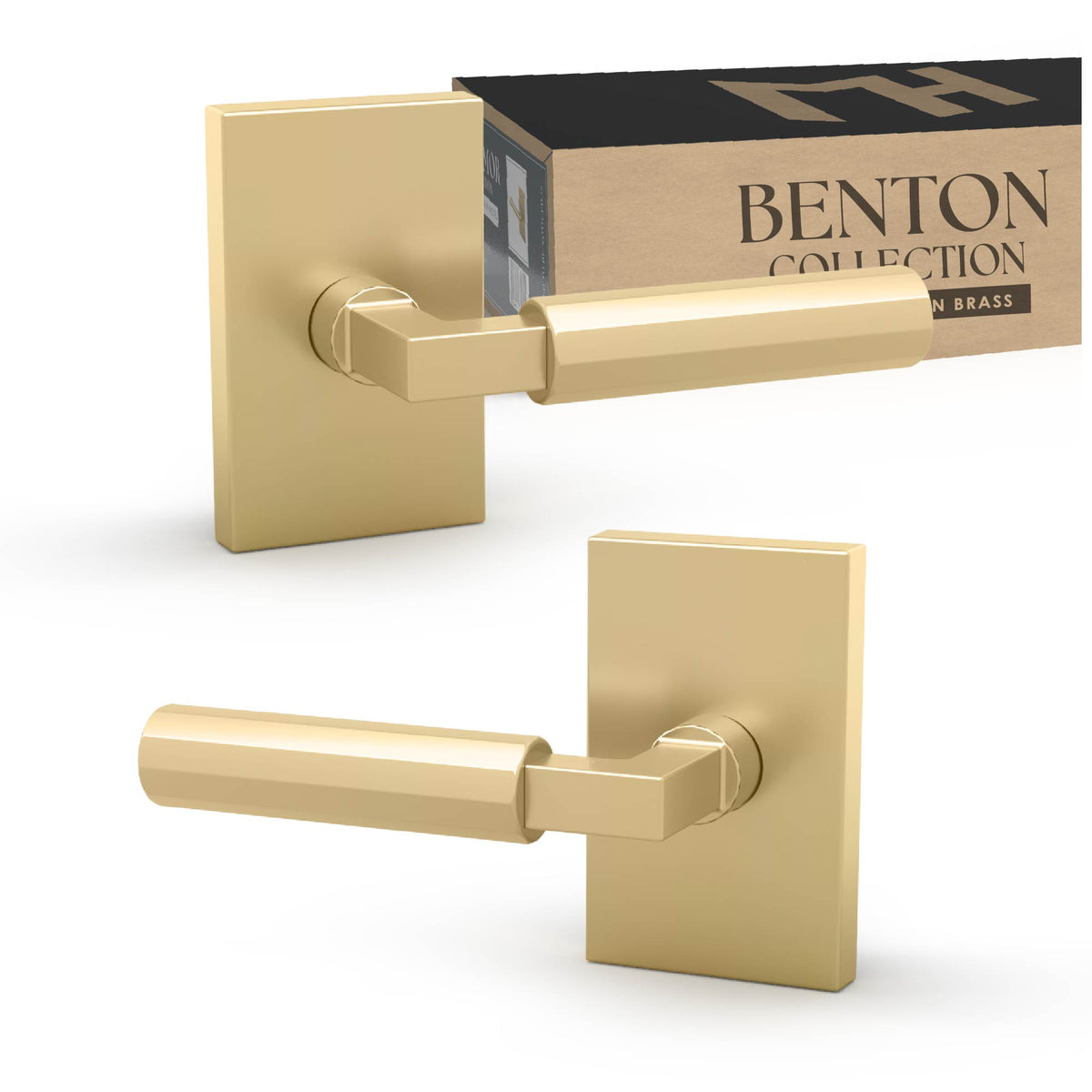 Two Benton Satin Brass dummy levers on rectangular rosettes beside product packaging