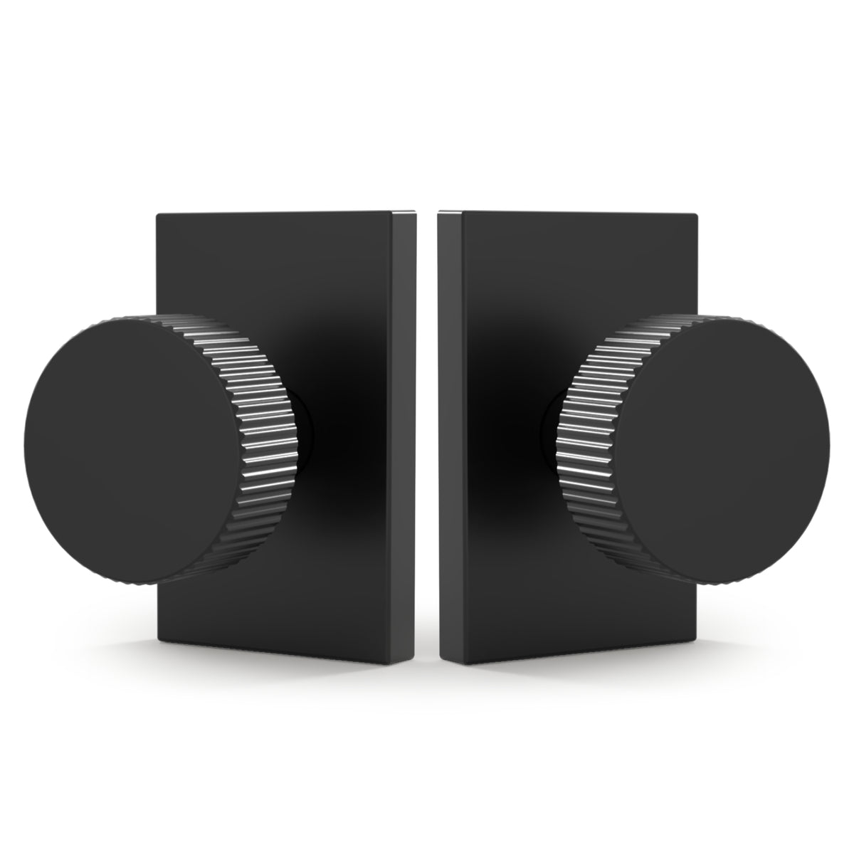 Front and rear views of Ribba Matte Black knobs with ribbed edges and rectangular rosettes