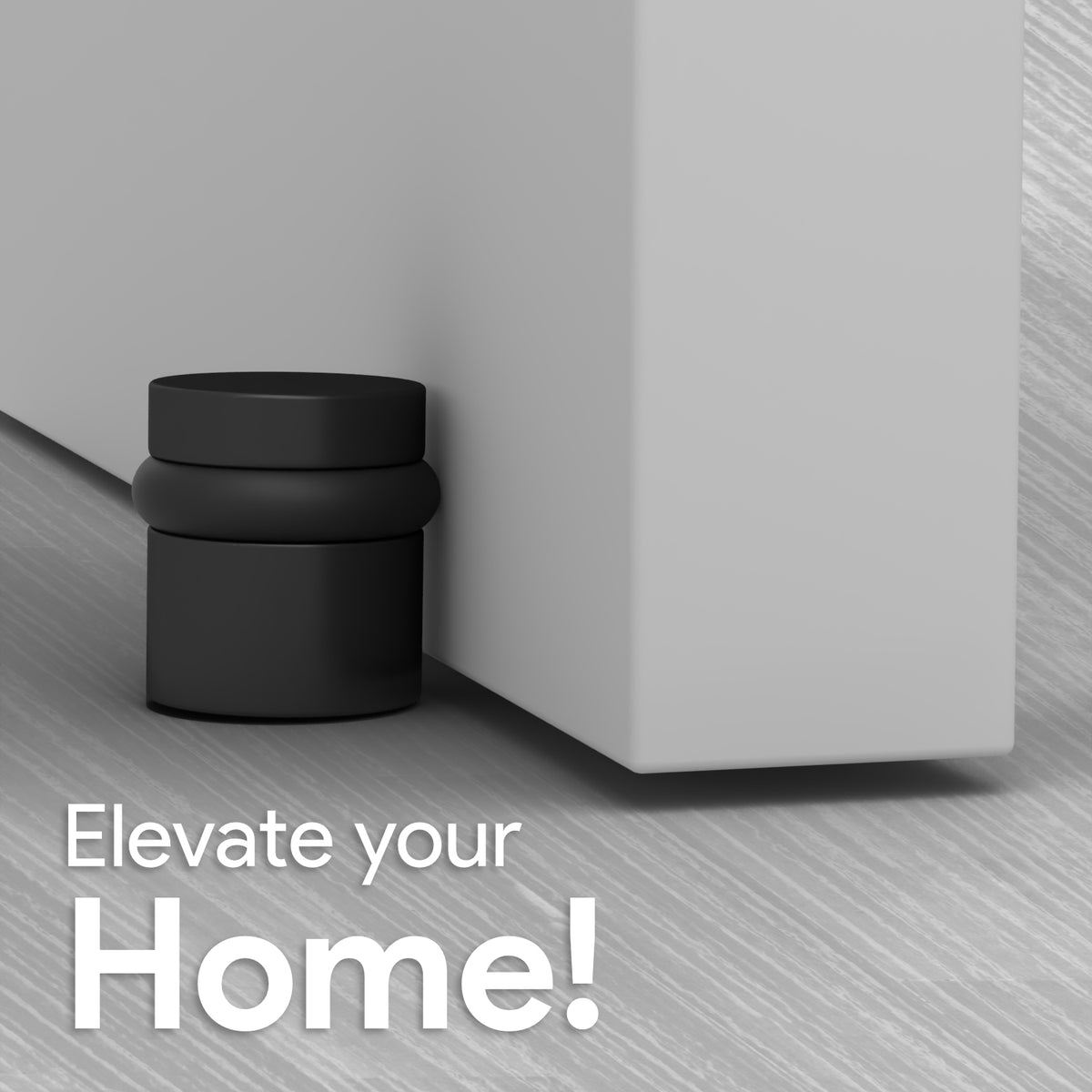 Matte black 1.5-inch Cylinder Door Stopper installed at the base of a gray door